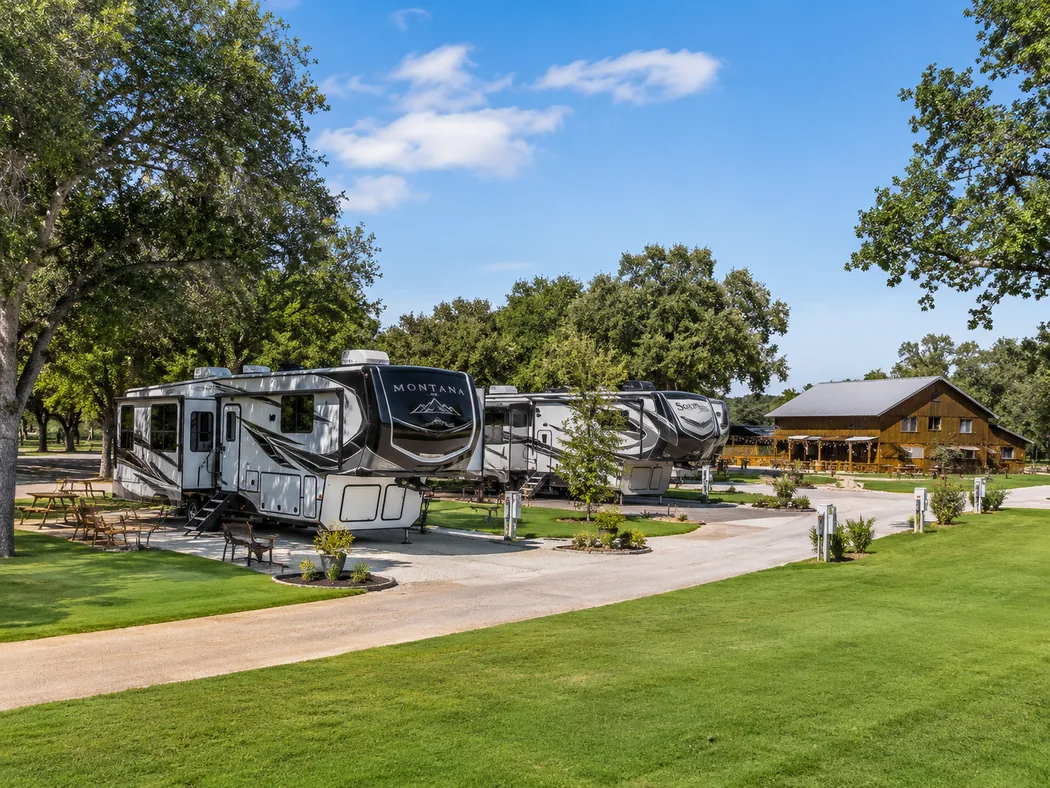 RVs parked on spacious sites beneath the oaks at Twin Oaks Resort