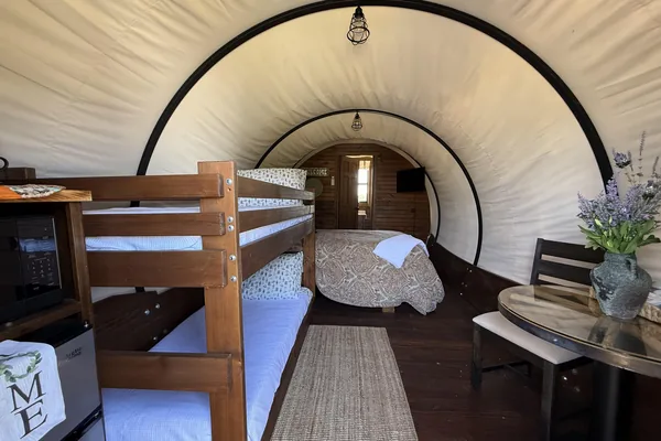 Inside the wagon: queen bed and bunks